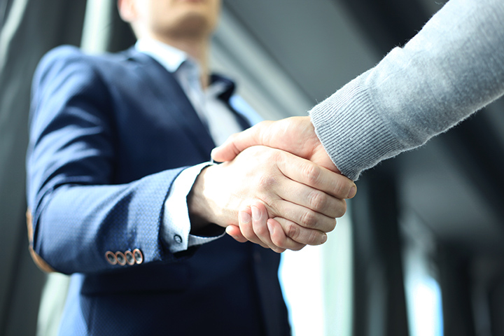 Attorney shaking hands with client